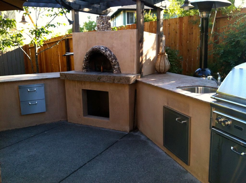 BBQ Grill and Oven with sink and counter.