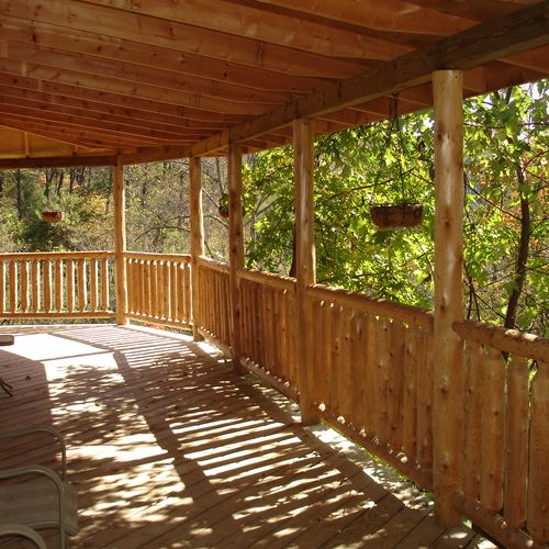 Another view of the deck and log railing .