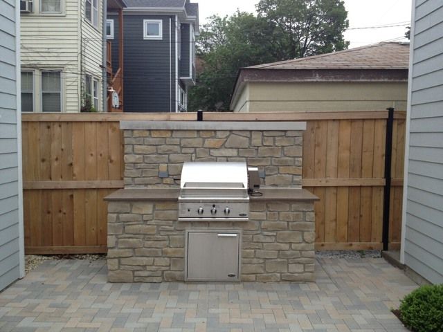 Brick paver patio and gas grill fireplace built by