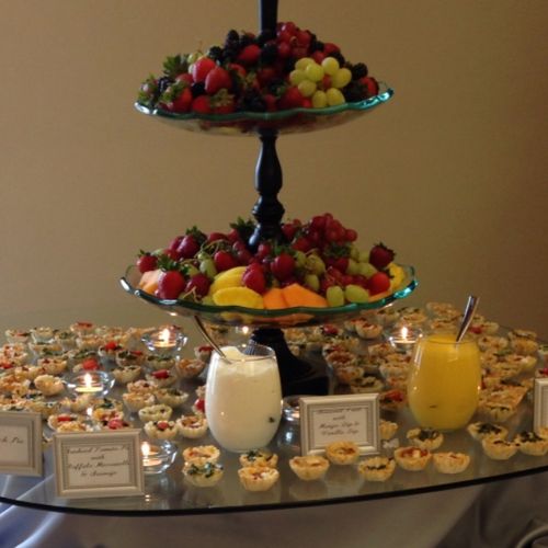 A wedding with a variety of fruit & mini quiches. 