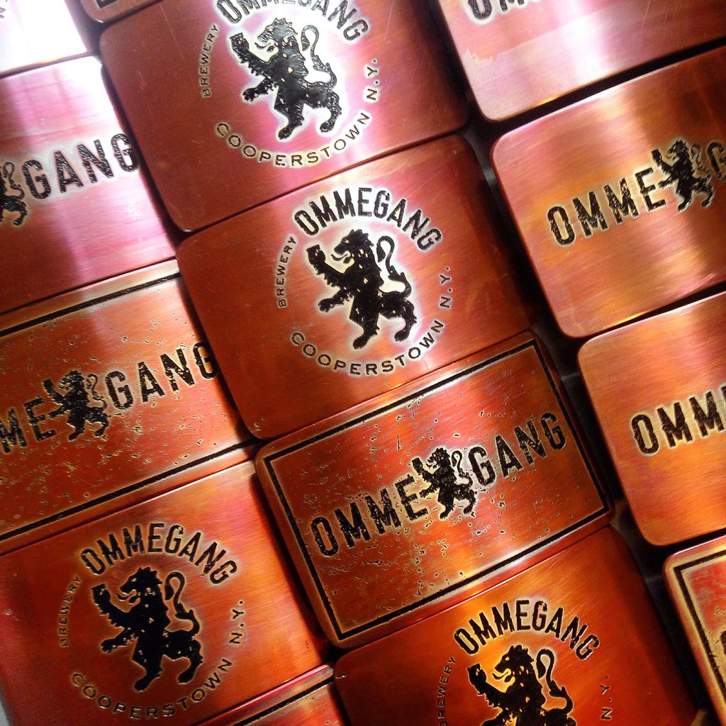 150 etched copper belt buckles for Ommegang Brewer