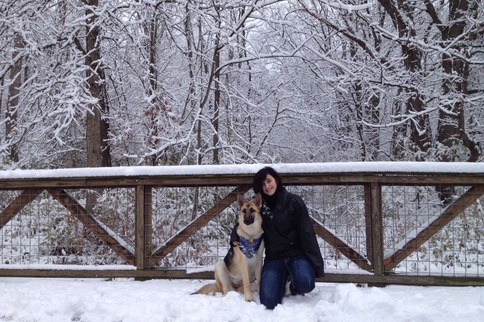 A happy girl and her well trained dog.