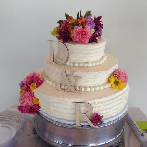 Three tier wedding cake with buttercream and fresh