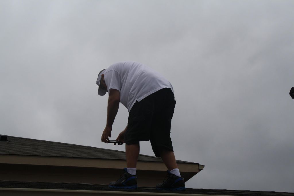 taking a pic of a torn shingle