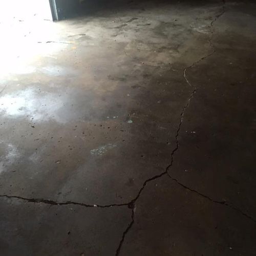 Cracked garage floor from water settlement underne