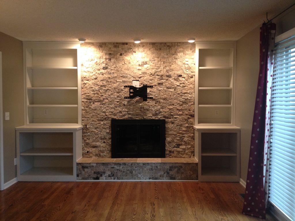 Custom book shelves surrounding new, refaced firep