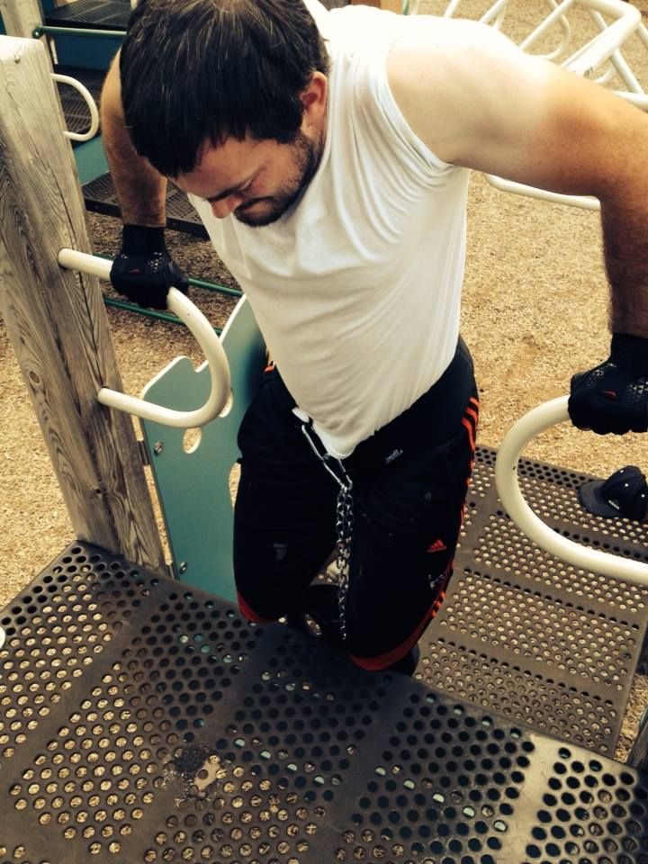 This is a weighted dip being performed at a playgr