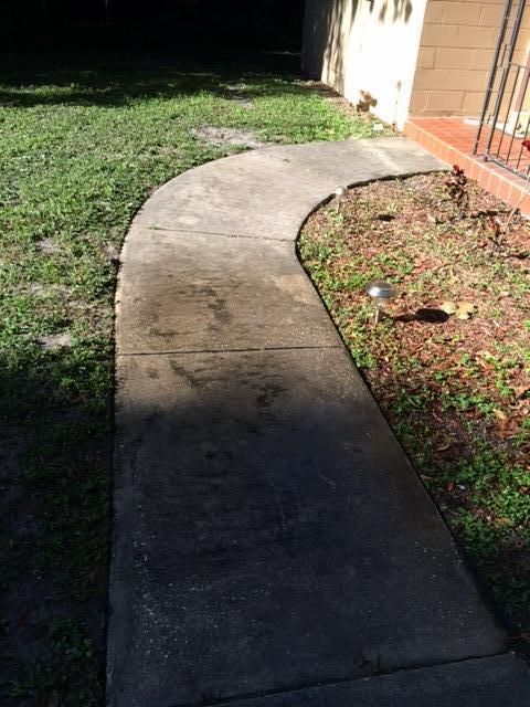Before photo of walkway to front door.
Deltona