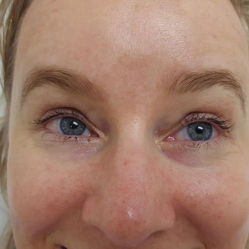 After: a happy client with defined lashes and brow