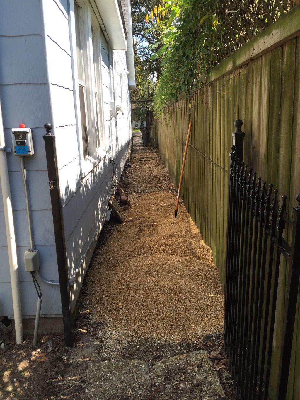 Leveling out this walkway with pea gravel.