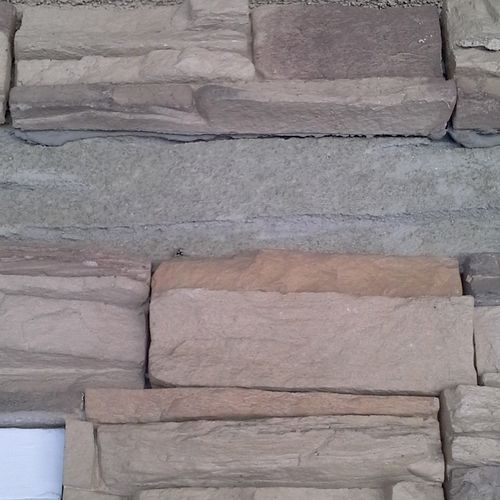 Missing and loose decorative stone siding.