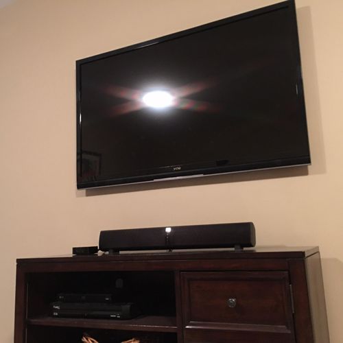 TV wall mount installation and cord concealment in