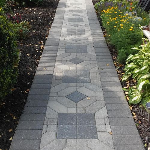 Tightened loose/wavy separated pavers and sealed w