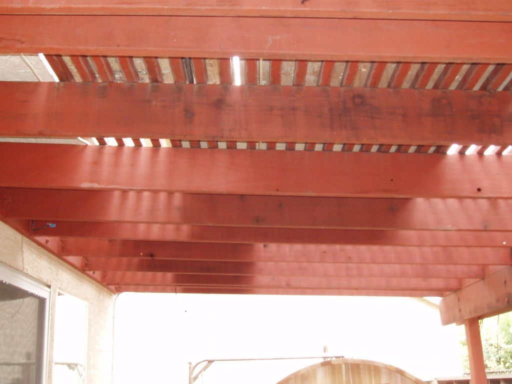 Stained wood and built arbor over paver patio.