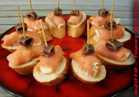 Toasts with home cured Salmon rolls stuffed with c