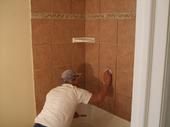 Finishing the grout in the new bathroom