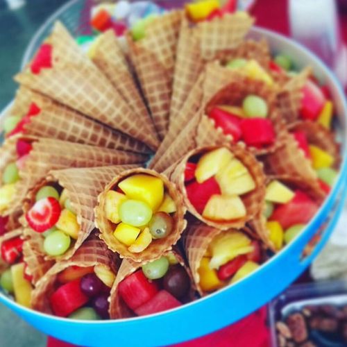 Summer waffle cones, filled with pineapple, grapes