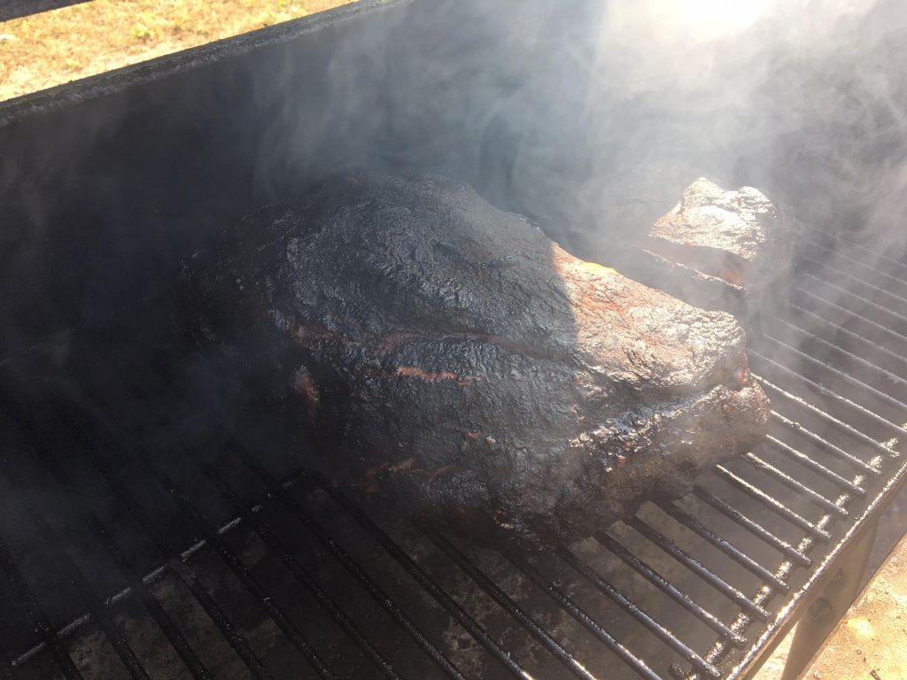 Pork shoulder slowly smoking into deliciousness
