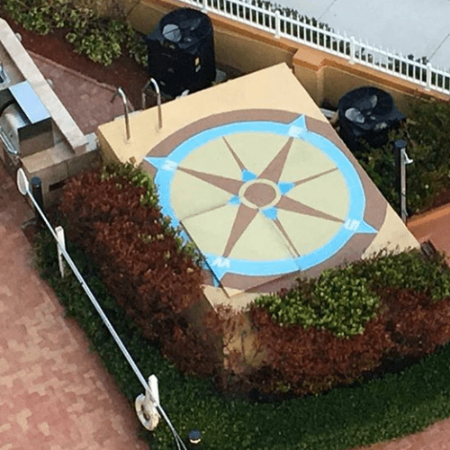 This is a mural of a compass on the top of a pool 