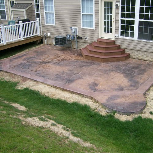 Stamped concrete pad, and custom composite stairs.