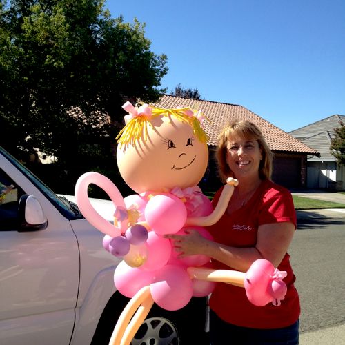 Carolyn Hadin delivering a giant balloon baby for 