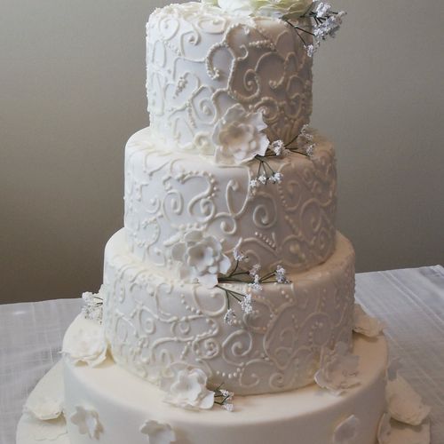 Traditional white wedding cake decorated with eleg