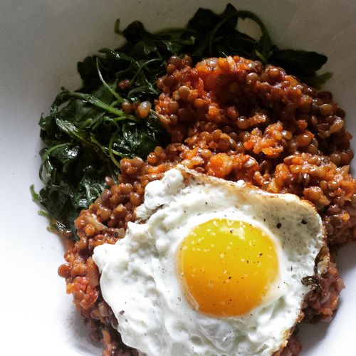 sauteed greens and spicy lentils with a fried egg 