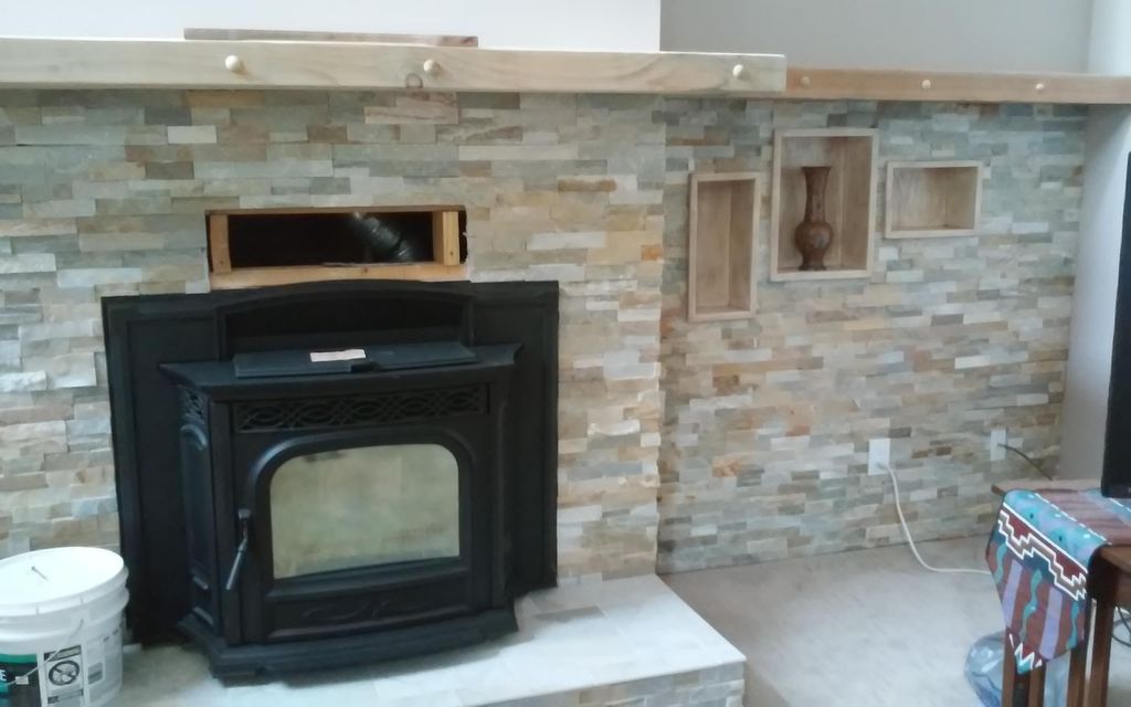Tile and pellet stove installation in progress.
