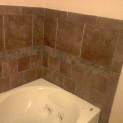 Ceramic tile (tub surround) placed in bathroom.