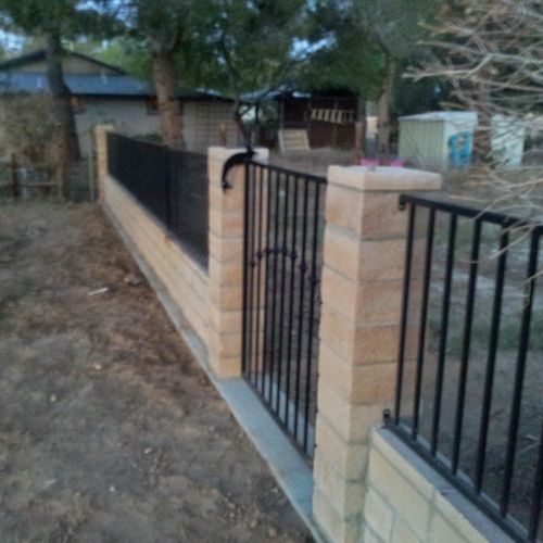 half block wall, half wrought-iron fence w/ simple