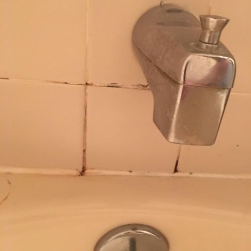 Water Damage behind the Bathtub faucet