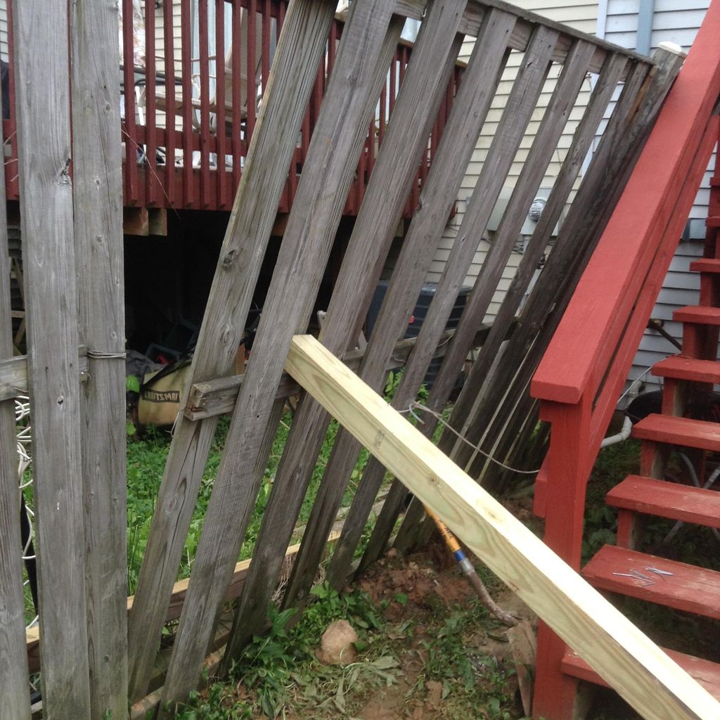 The leaning fence was laying against the customers