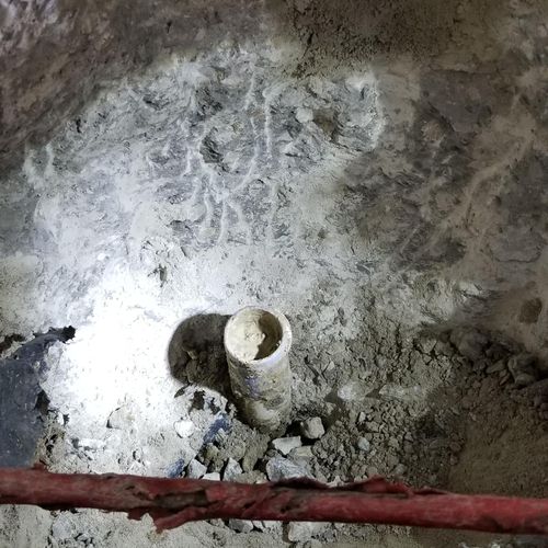 Digging concrete out of pipes under foundation