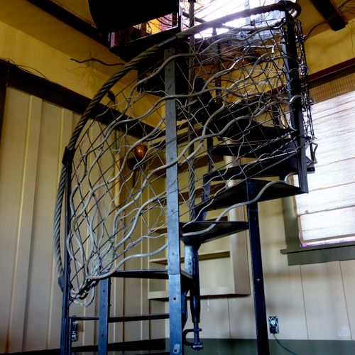 Blackened steel Spiral staircase and wire rope han