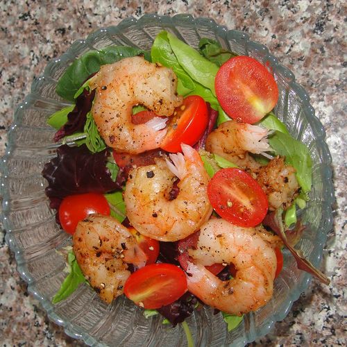 Spicy shrimp salad with grape tomatoes, carrots, a