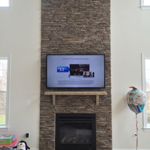 TV installation above fireplace.  The TV mount nee