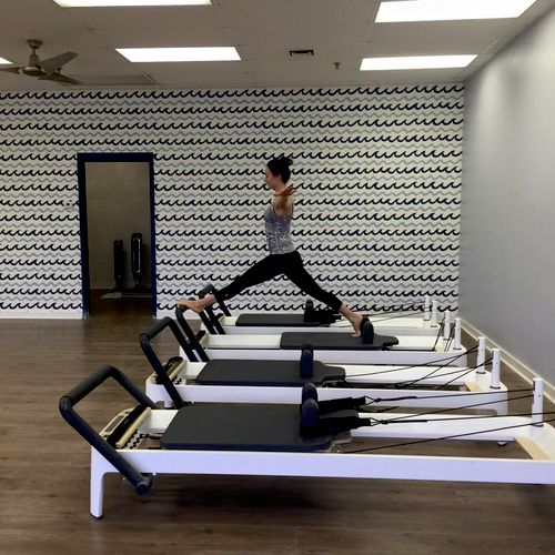 Practicing my splits on the Pilates reformer.