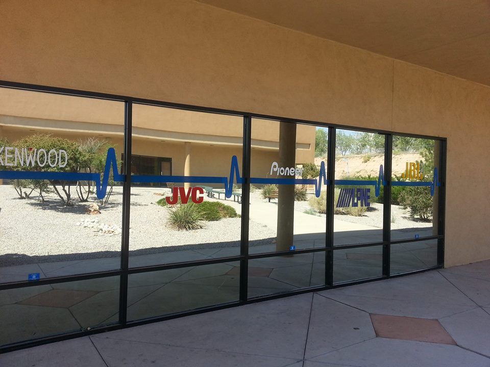 Clean windows and add graphics to store front.