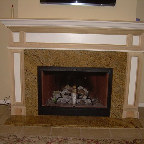 Gas & wood burning fire place and custom wood surr