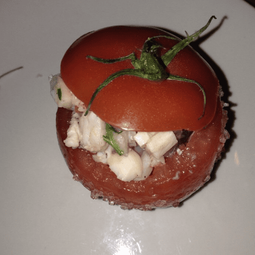 Seafood salad with a vine ripened tomato.