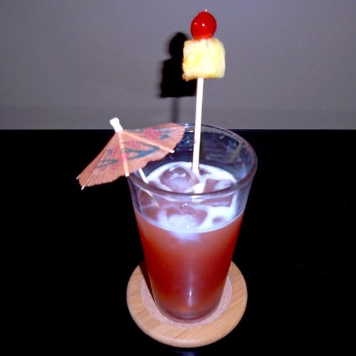 Singapore Sling, garnished with a pineapple wedge 