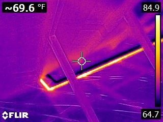 Thermal image of hot and cold water pipes in attic