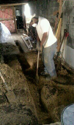 Digging hole to lay pipes down for plumbing