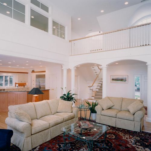 Living Room featuring Vaulted Ceiling and Balcony.