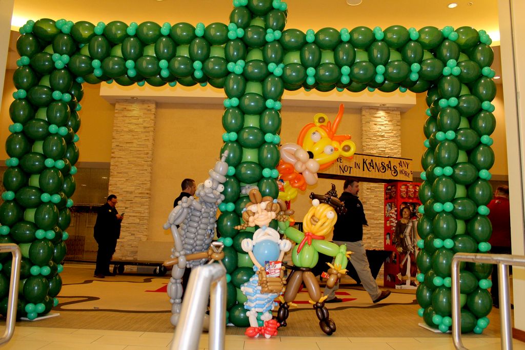 A Wizard of Oz arch with the 5 characters followin