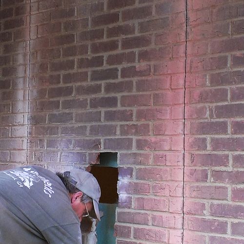Demoing a brick wall to install a door