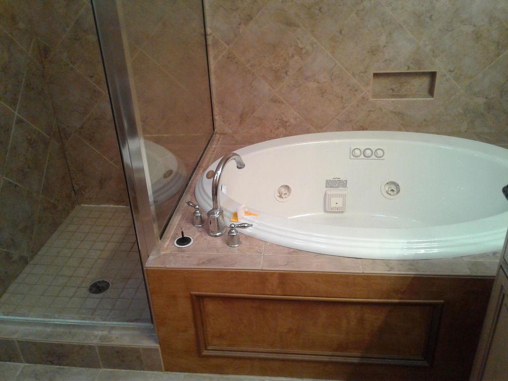 New Jacuzzi tub installed with side by glass showe