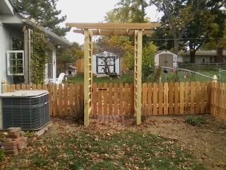 Custom arbor with 4 foot space picket fence.