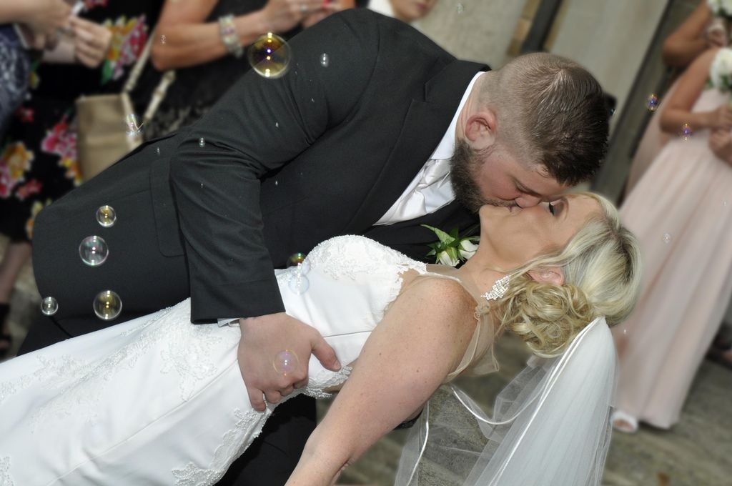 Portrait of Bride and Groom Kissing after Ceremony