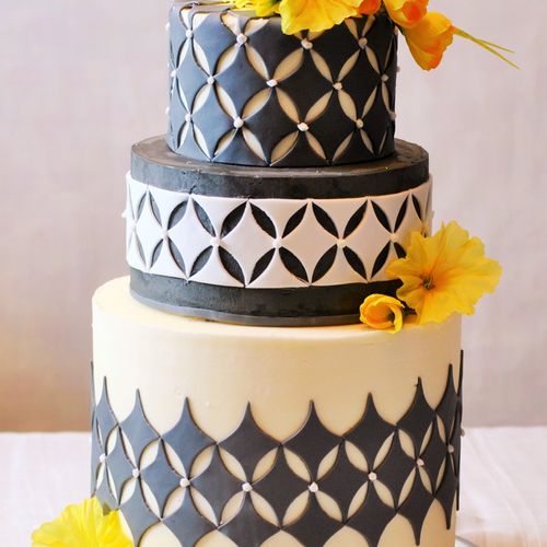 A modern grey and white wedding cake frosted with 